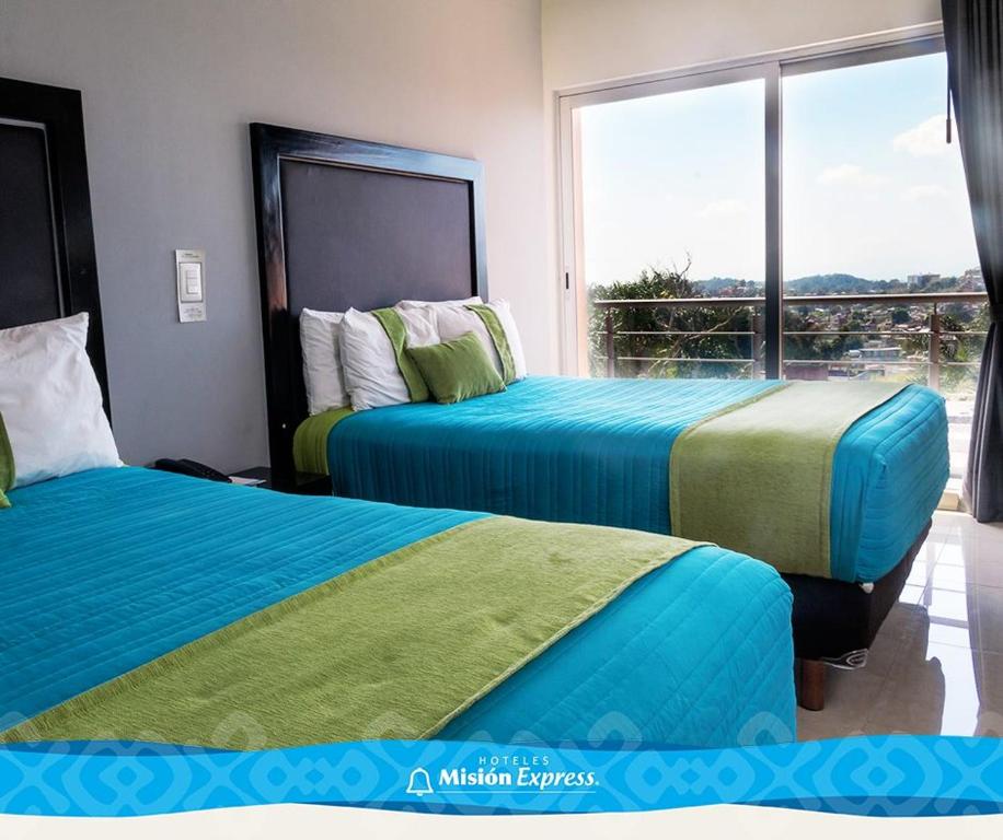 Postel nebo postele na pokoji v ubytování Hotel Misión Express Xalapa