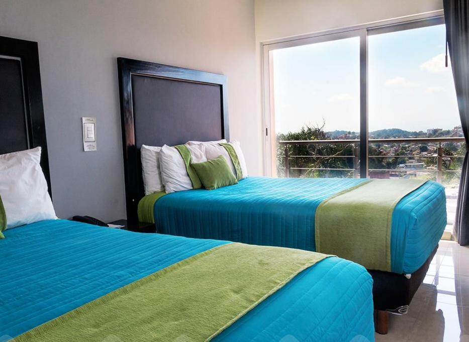 Кровать или кровати в номере Mision Express Xalapa Centro