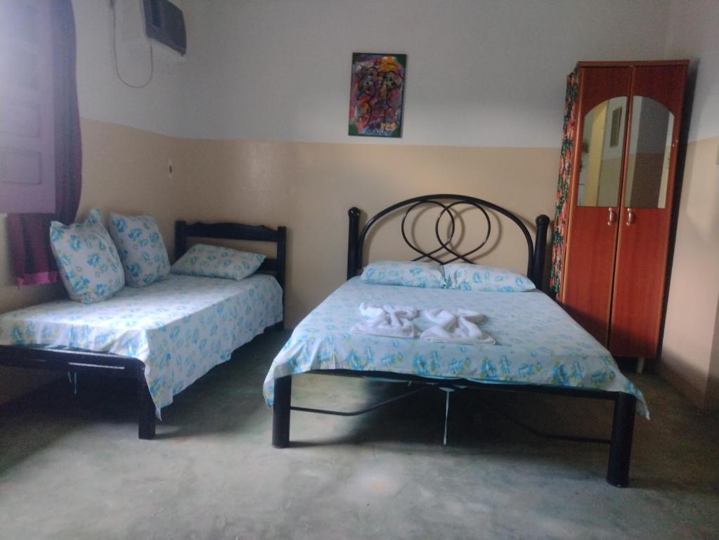 Postel nebo postele na pokoji v ubytování Residencial Ravasco