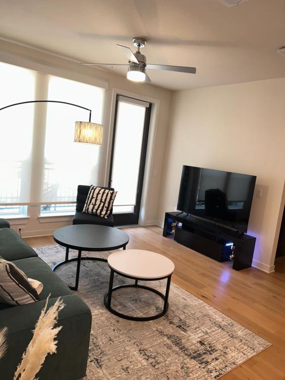 a living room with a couch and a tv at Luxe Mid-Downtown apartment in Houston