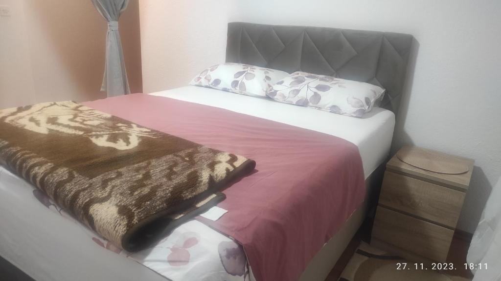 a bed in a small room with at Apartman.nemanjica bb in Nevesinje