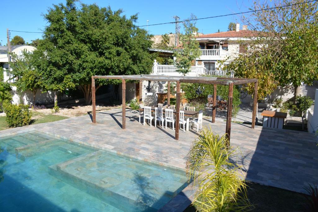 a patio with a gazebo and a table and chairs at Casa de Gaia in Alicante