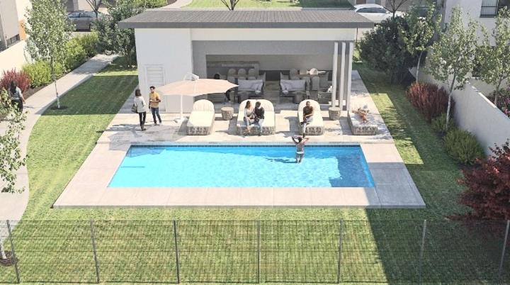 a swimming pool in a yard with people standing around it at Feel at Home Mbombela Self Catering in Nelspruit