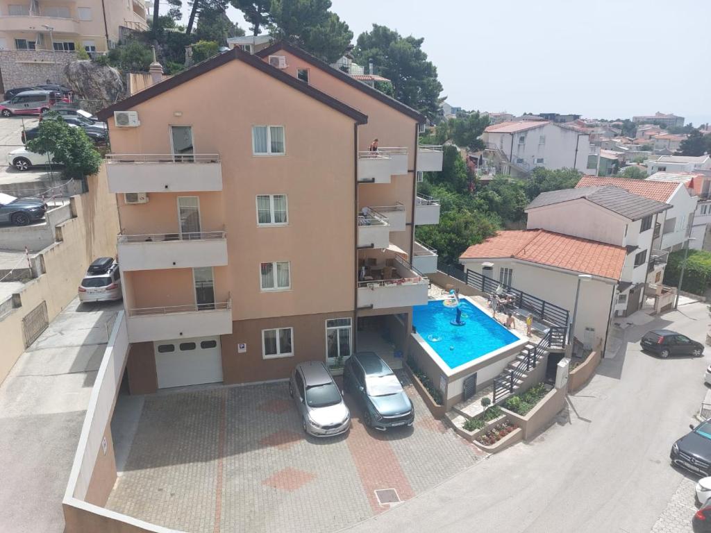 an aerial view of a building with a swimming pool at Apartments Vila Adrijana & Fitness Studio WOLF BV in Baška Voda