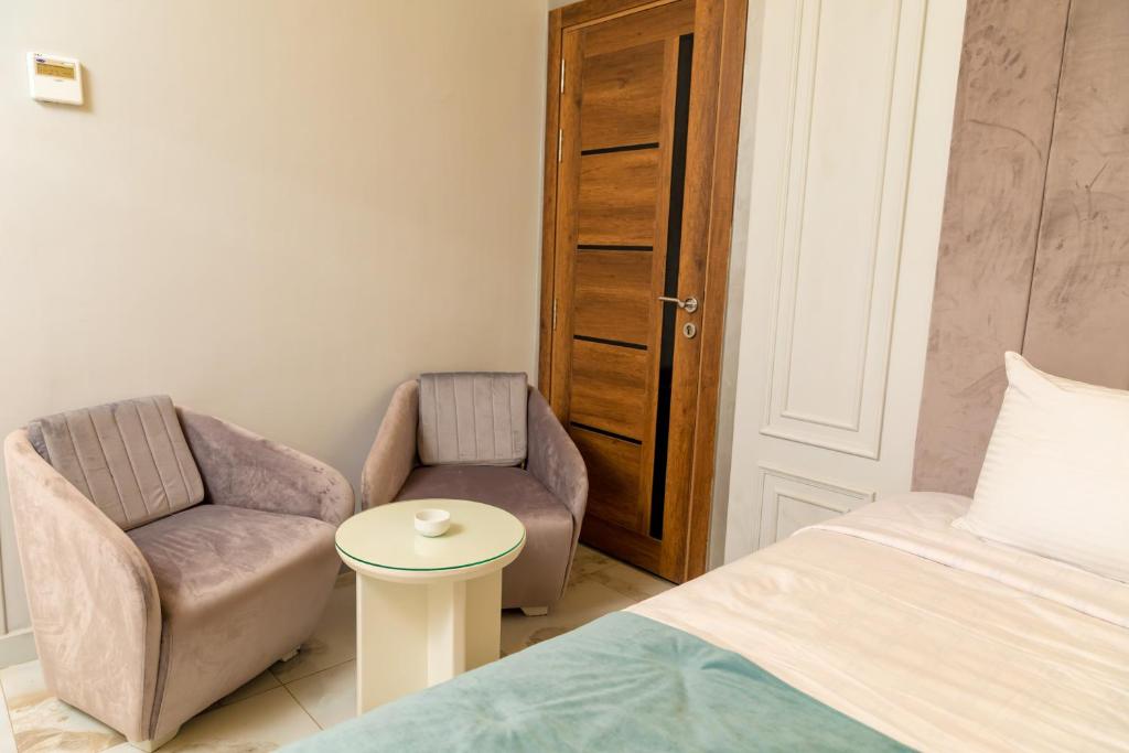Postel nebo postele na pokoji v ubytování Nile Club hotel
