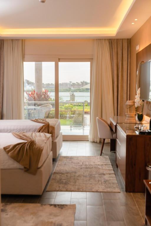Postel nebo postele na pokoji v ubytování Nile Club hotel