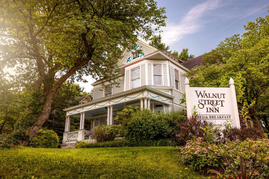 a white house with a sign in front of it at Walnut Street Inn in Springfield