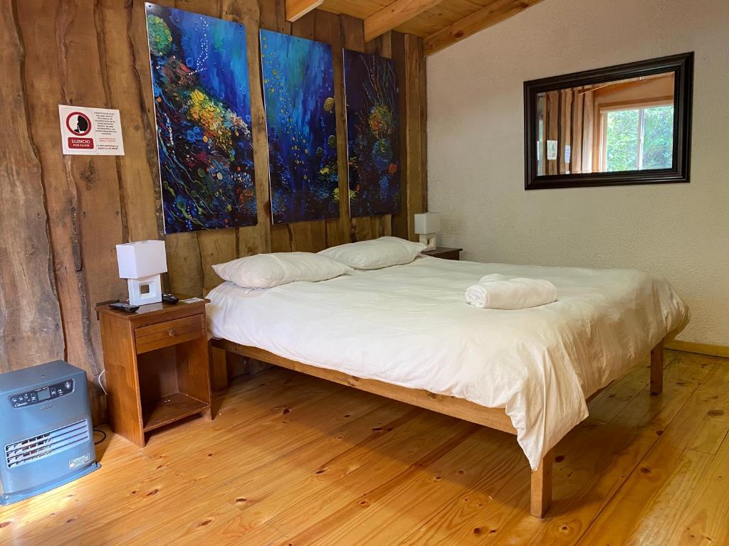 Llit o llits en una habitació de Hostal Plaza Chiloe