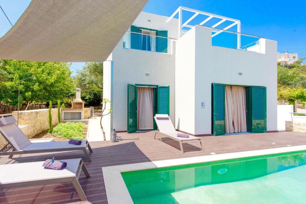 a villa with a swimming pool and a house at Luxury Villa Murtal with private pool in Gerani