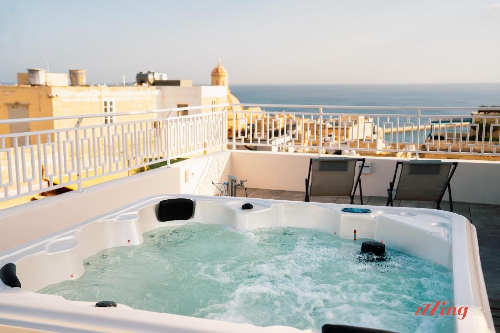 a hot tub on the balcony of a building at Avalon Boutique in Valletta