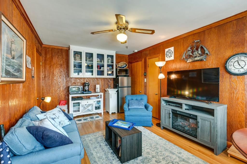 a living room with a blue couch and a tv at Pet-Friendly Nashville Home about 4 Mi to Airport! in Nashville