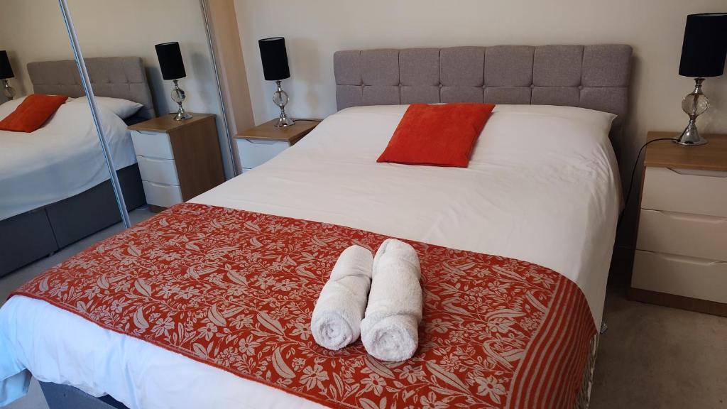 a bedroom with a bed with two towels on it at Baystays Scenic View in Swansea