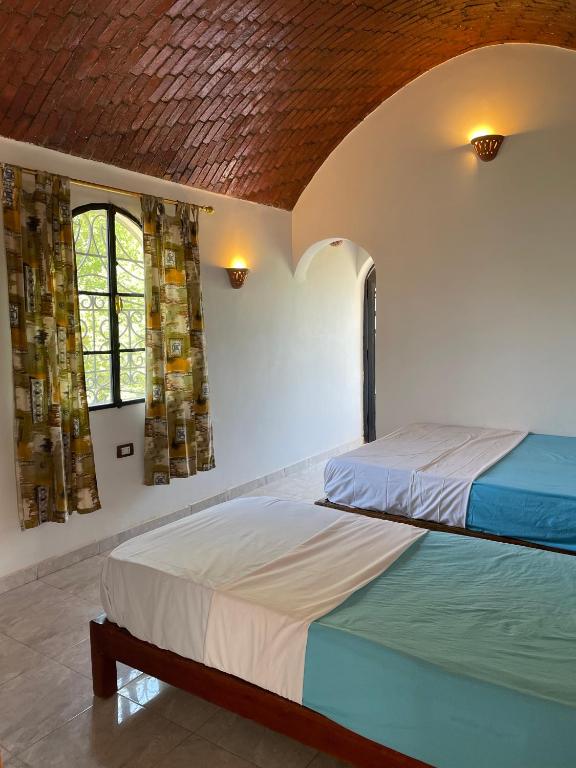 Postel nebo postele na pokoji v ubytování Nubian Holiday House Aswan