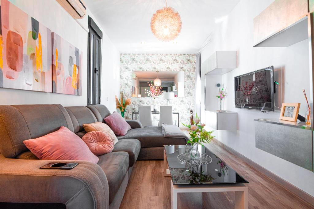 a living room with a couch and a table at Edomus Gran Plaza Boutique in Seville