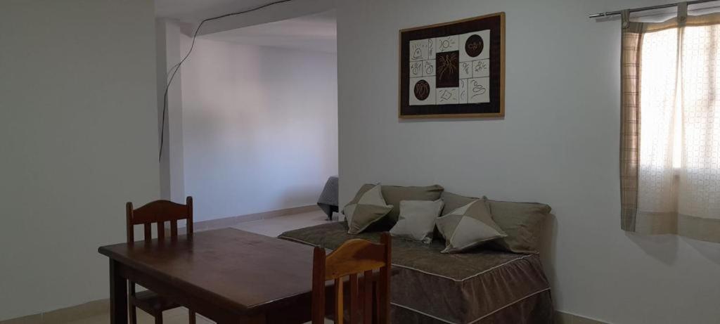 a living room with a table and a couch at Monoambiente Céntrico2 in Santiago del Estero