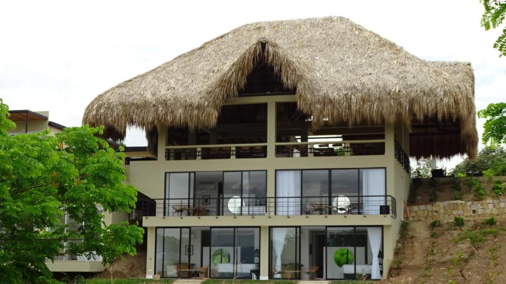 a large building with a thatched roof at Selva Serena in Anapoima