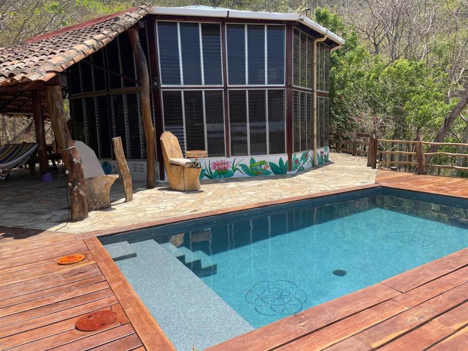 a house with a swimming pool and a gazebo at Jungle Farm, Digital Detox Cottage in Nicaragua in La Esperanza