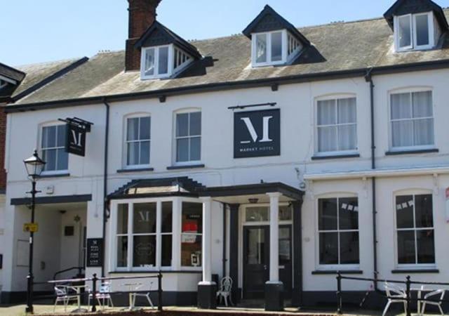 a large white building with a sign on it at The Market Hotel in Alton