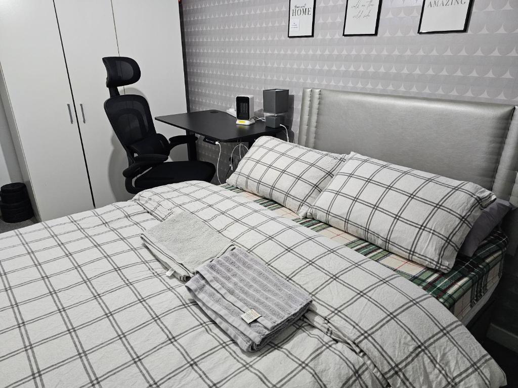 a bedroom with a bed with a table and a chair at Bridgepay Double Room in Kenton