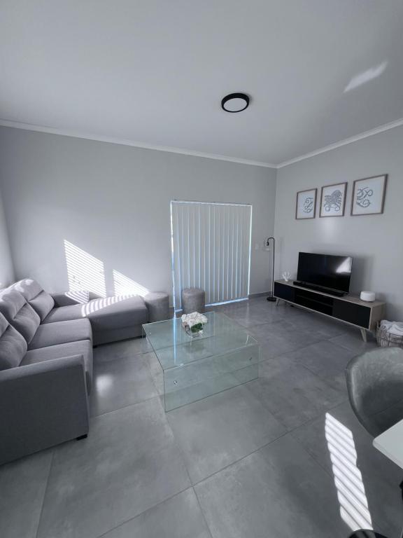 a living room with a couch and a glass table at Cosea Langebaan in Langebaan