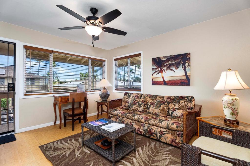 a living room with a couch and a table at Kona Shores 221 STVR #19-390879 in Kailua-Kona