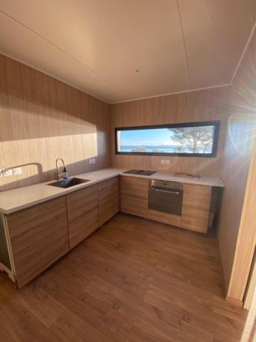 a small kitchen with a sink and a window at HAVRE DE PAIX LES PIEDS DANS L&#39;EAU in Istres