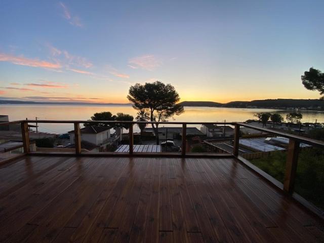 a wooden deck with a view of the water at HAVRE DE PAIX LES PIEDS DANS L&#39;EAU in Istres