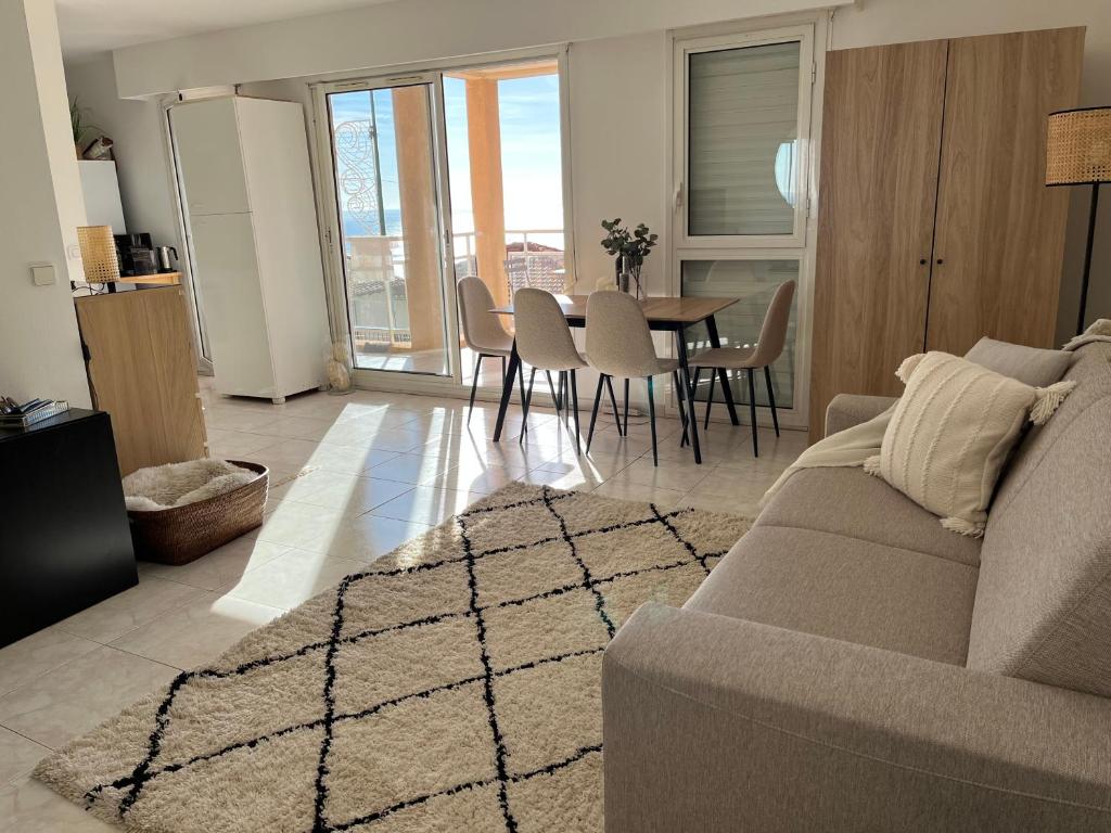 sala de estar con sofá, mesa y sillas en Appartement a deux pas de Monaco, en Beausoleil