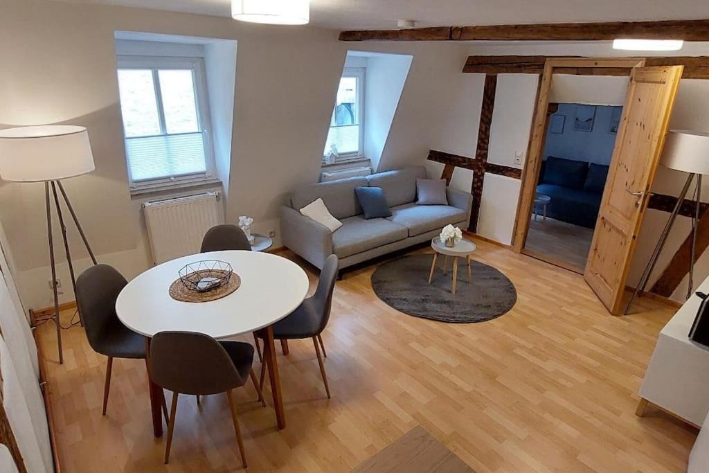 a living room with a table and a couch at Zentrale Altbauwohnung mit Flair in Schwäbisch Hall