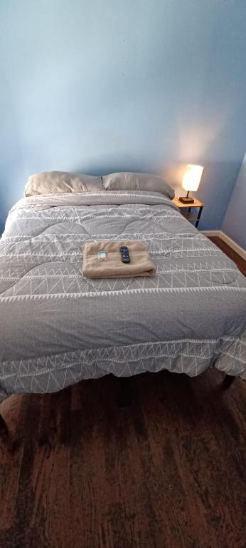 a bed with a wooden tray on top of it at willoughby inn in Newark