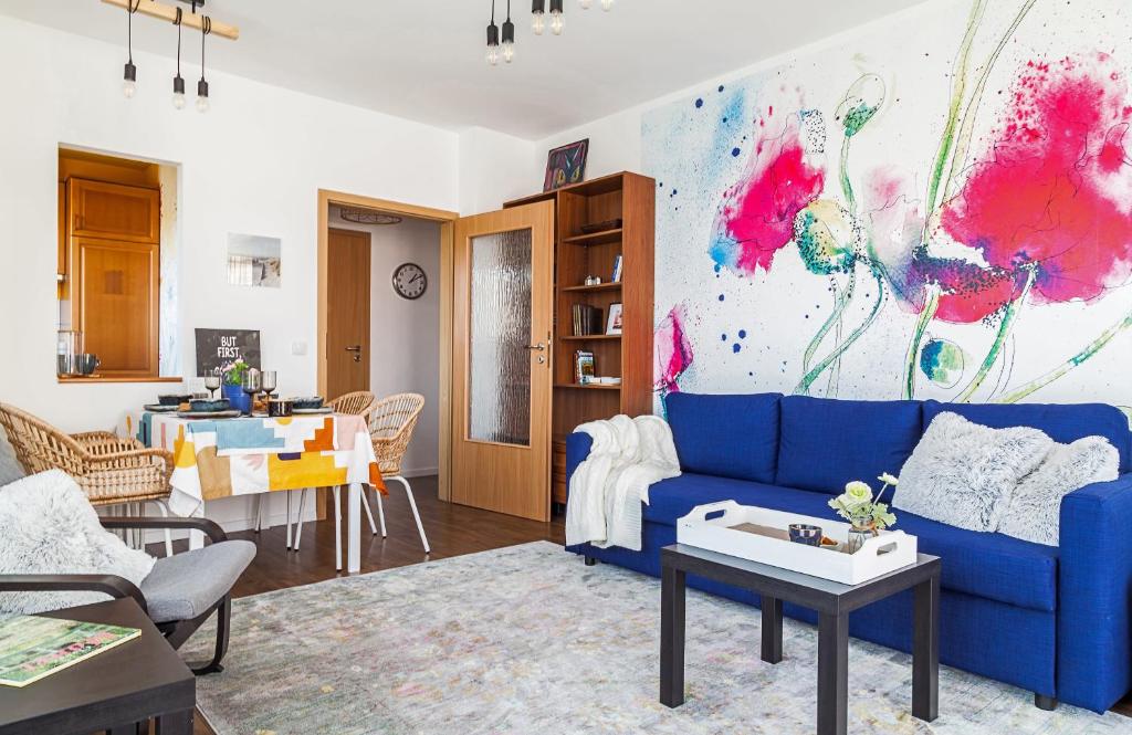 a living room with a blue couch and a table at Almere with FREE Parking in Budapest