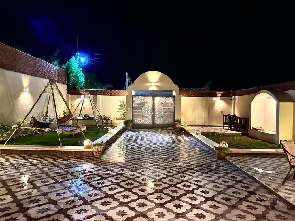 a house with a stone courtyard at night at West Bank luxury villa in Luxor