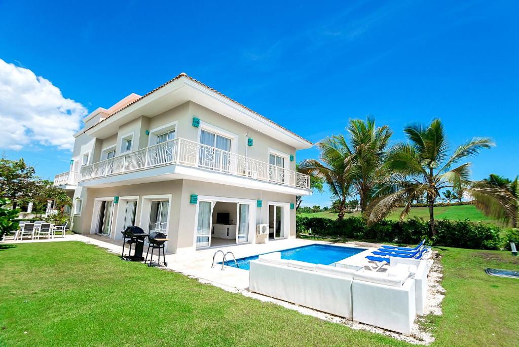 a large house with a swimming pool in the yard at Luxury Private Villas with Pool Beach BBQ in Punta Cana