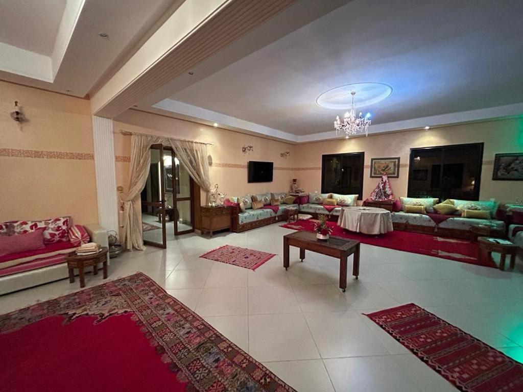 a large living room with couches and rugs at Paradise house in Marrakesh