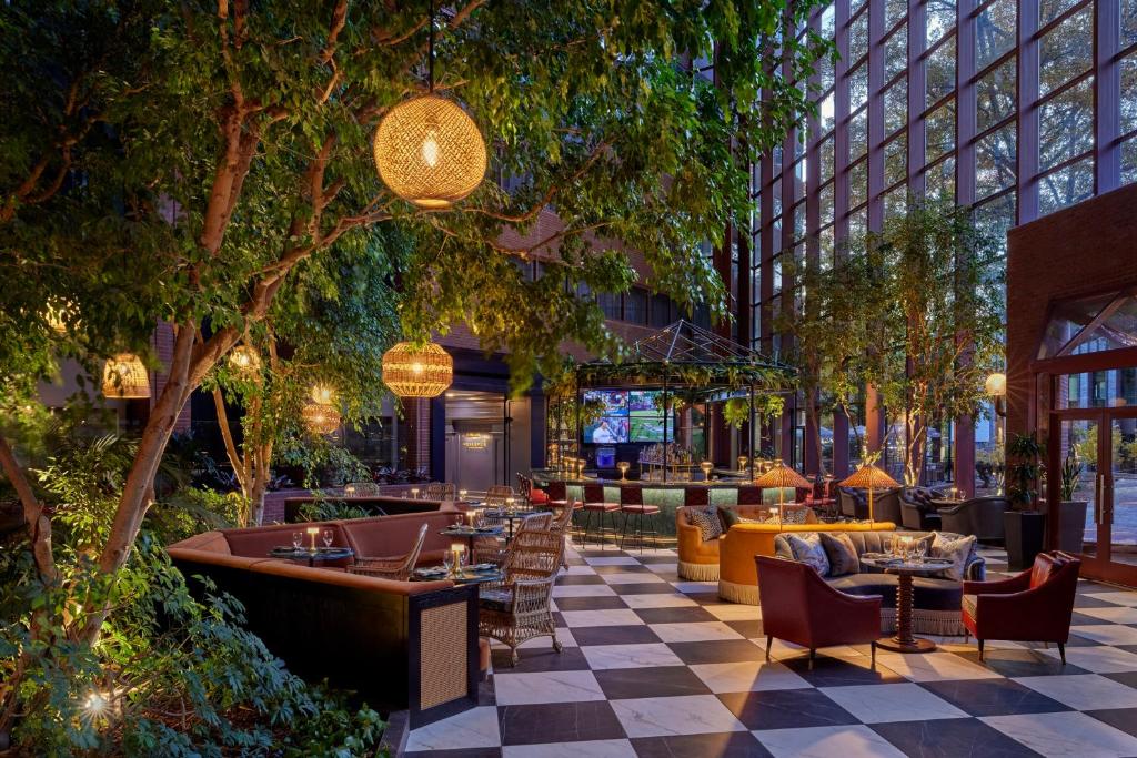 a restaurant with tables and chairs in a building at Omni Charlottesville Hotel in Charlottesville