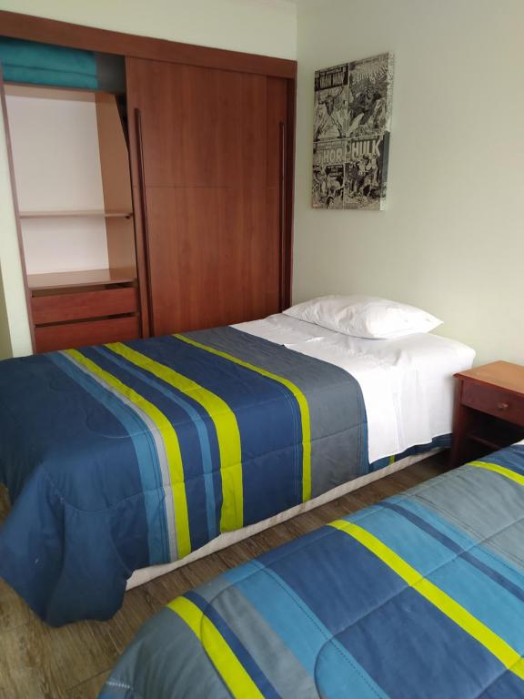 a bedroom with two beds and a bunk bed at Depto. Nautilus Piso 11 in Iquique