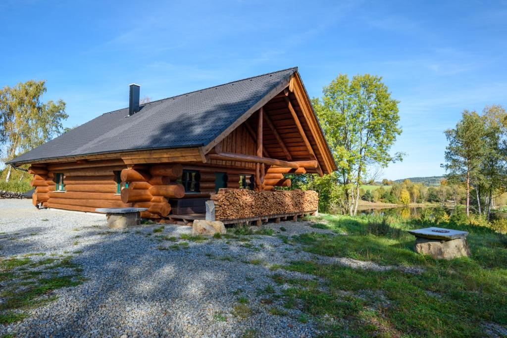 a log cabin with a black roof at SRUB KVETONOV in Kaplice