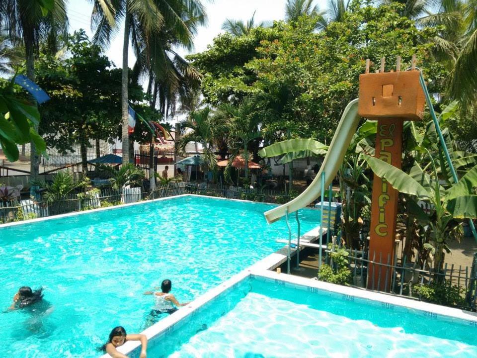 people in a swimming pool at a resort at El Pacific Surf House in Sipacate