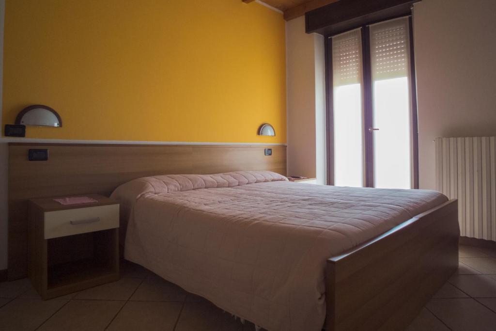 Łóżko lub łóżka w pokoju w obiekcie Albergo Ristorante Innocenti