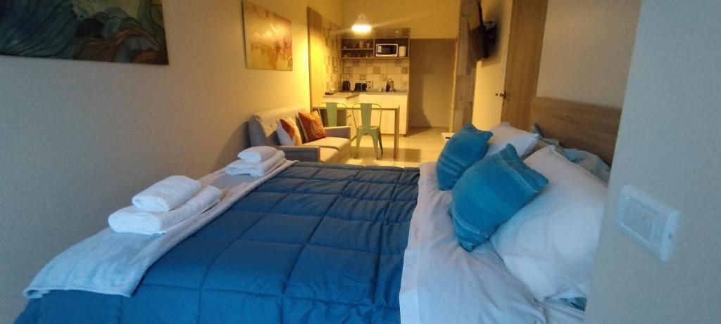 a bedroom with a blue bed with blue pillows at Marejada in Comodoro Rivadavia