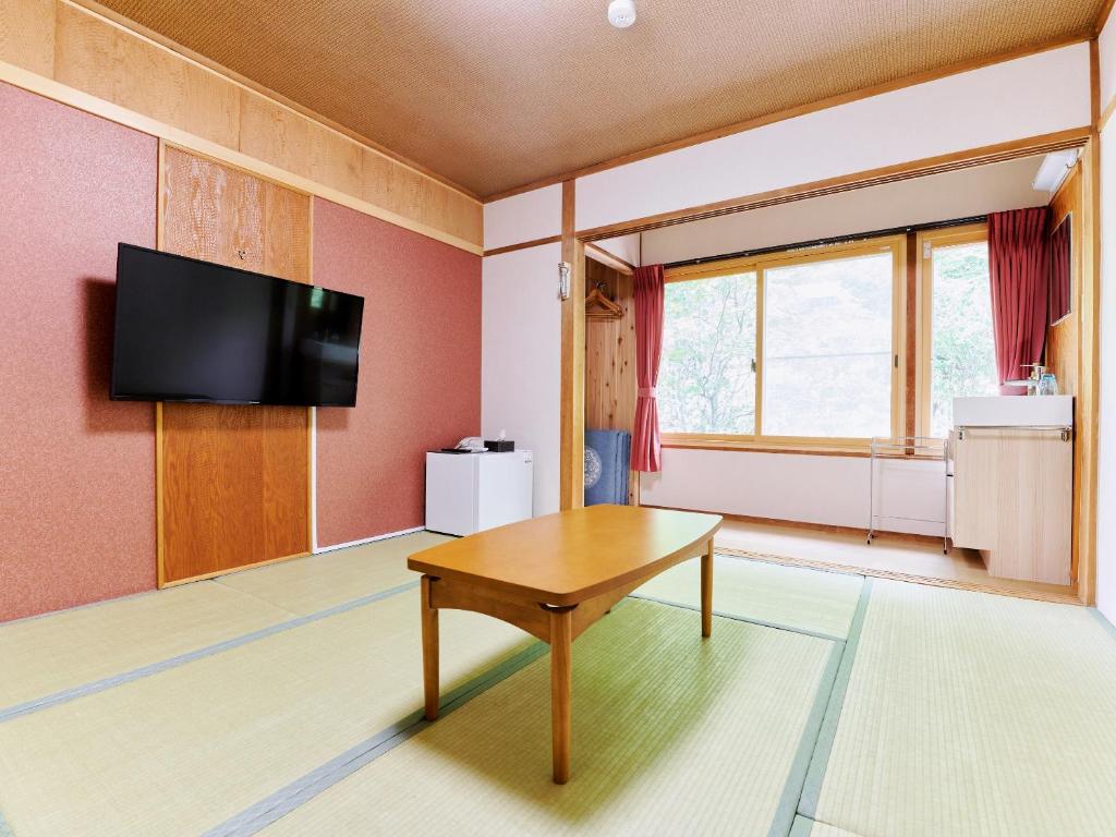 TV a/nebo společenská místnost v ubytování Ishinoyu Lodge