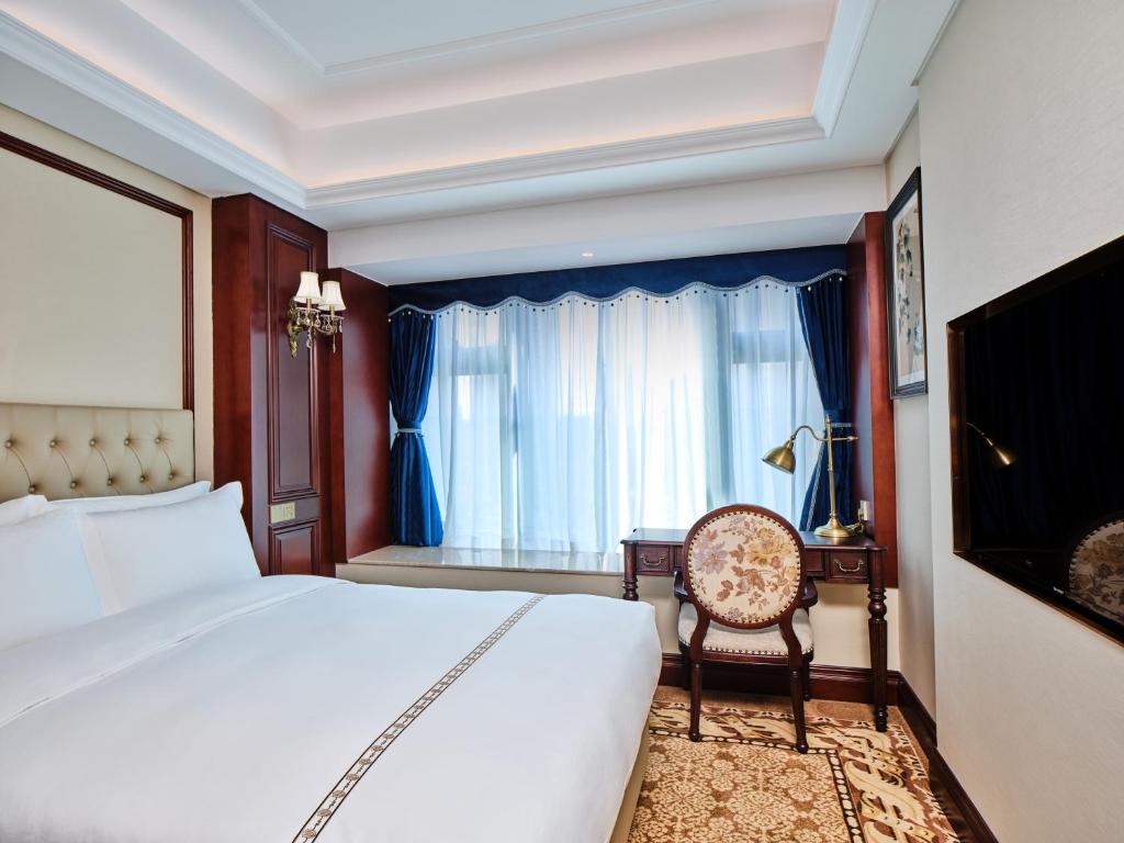Postel nebo postele na pokoji v ubytování Guangming CIMC Executive Hotel Shenzhen