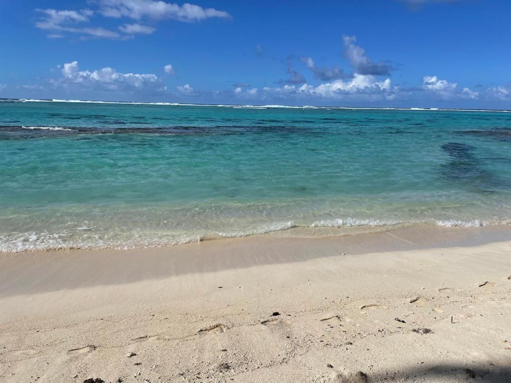 a beach with the ocean and the sand at Parea Lodge Huahine BUNGALOW F2 #Miti in Parea