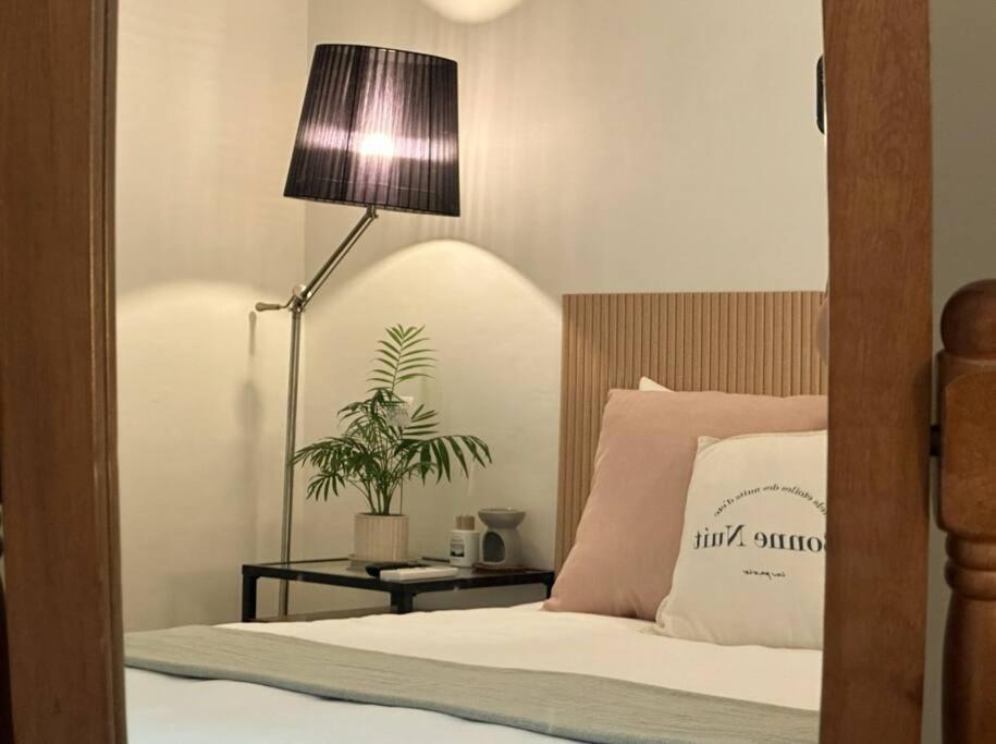 a bedroom with a bed with a lamp and a plant at Athome - Foreigner Only in Seoul