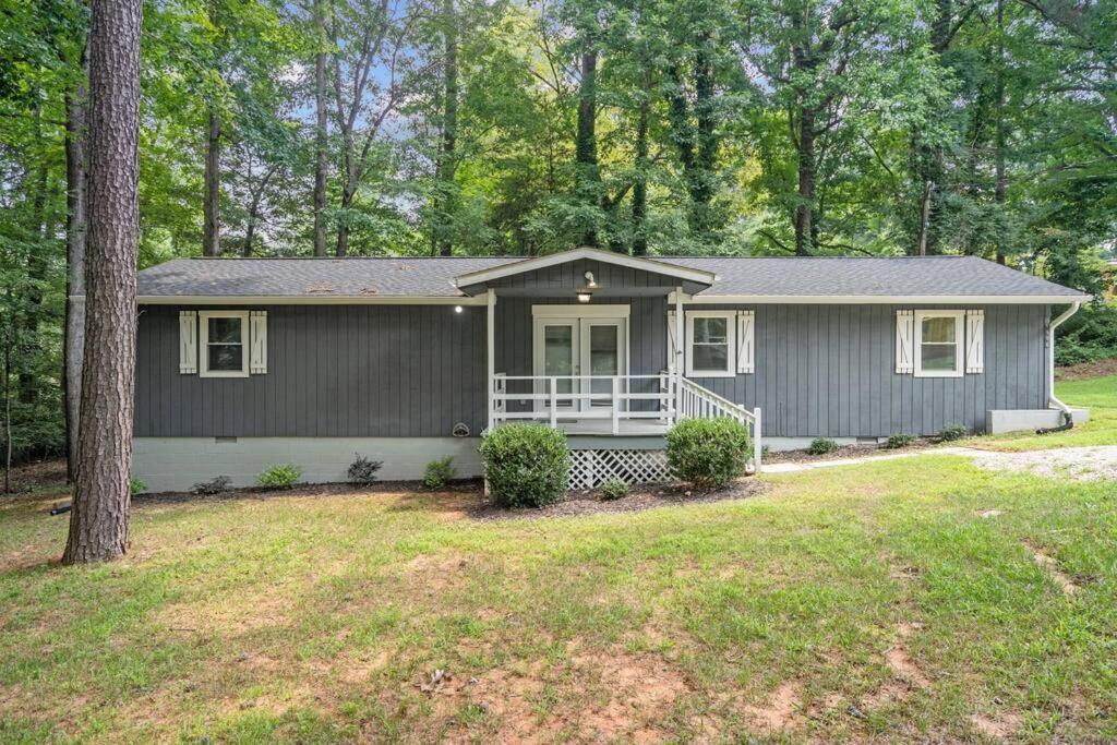 a home with a gray house with a porch at Spacious home- near Airport, Crabtree Mall & Food in Raleigh