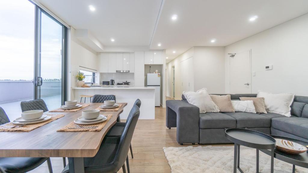 a living room with a table and a couch at Central Canterbury Charm Sky View Free Parking in Sydney
