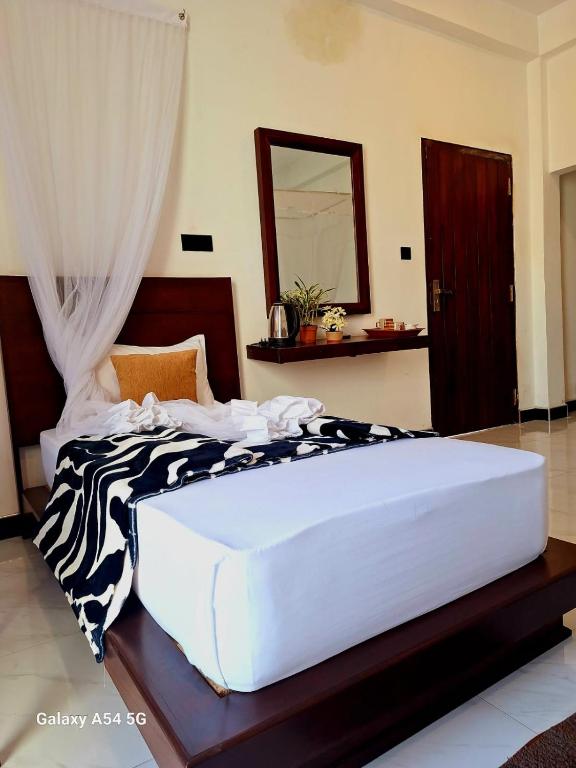 Postel nebo postele na pokoji v ubytování Ella Odyssey Inn