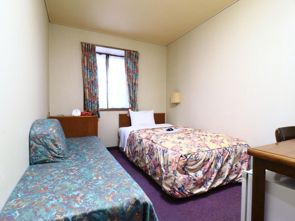 Postel nebo postele na pokoji v ubytování Shinseto Station Hotel