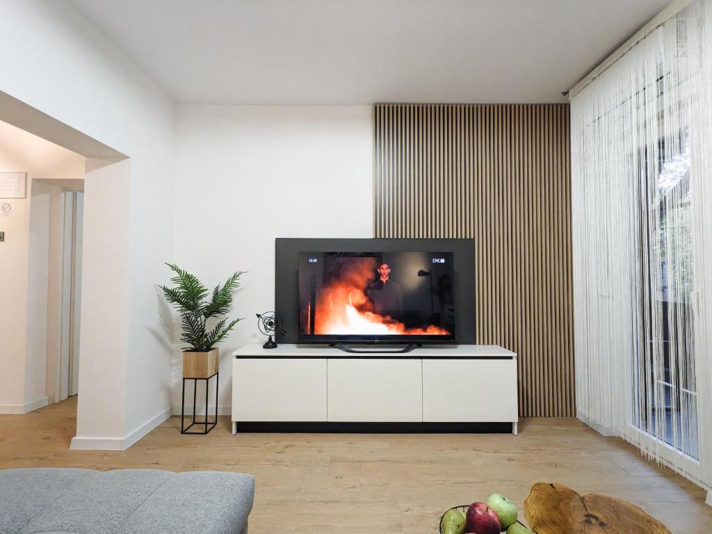a living room with a flat screen tv on a white cabinet at Apartment Exclusive - Self check In in Osijek