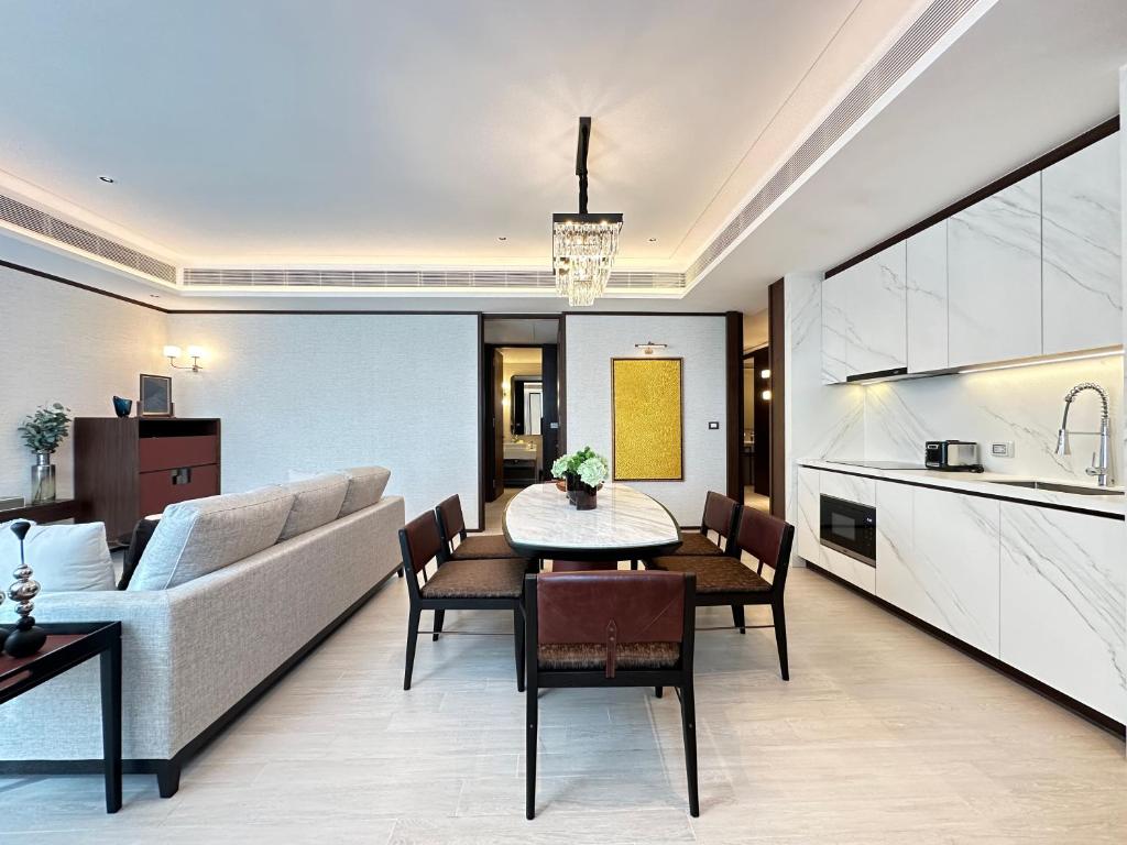 An open-plan suite lounge and dining area with a fitted kitchenette.